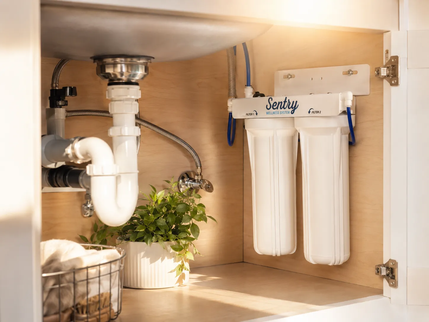 Sentry H2O Undersink System installed under a kitchen sink beside the plumbing